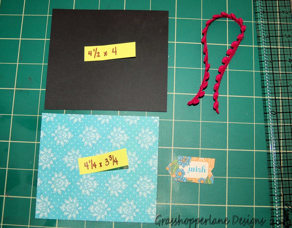 Cut a piece of black cardstock and a piece of decorative paper to the sizes listed above. this will create a photo mat for the outside of our envelope.