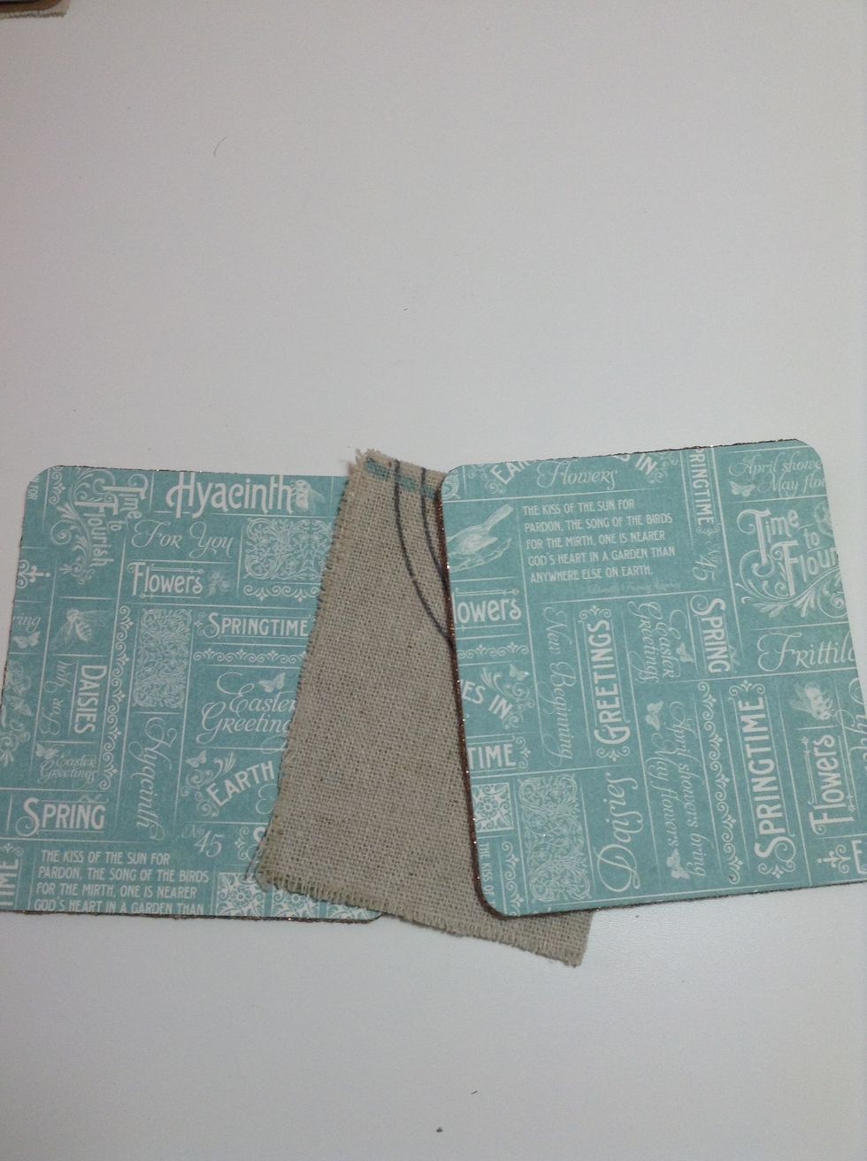 Cut a piece of burlap/ cotton fabric for to make the spine, and cut two pieces of Time to Flourish paper. You'll add to the back cover. And glue them to the piece of fabric.