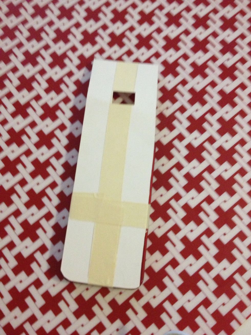 Cut a piece of card paper that is 2 inches longer than your iPhone.