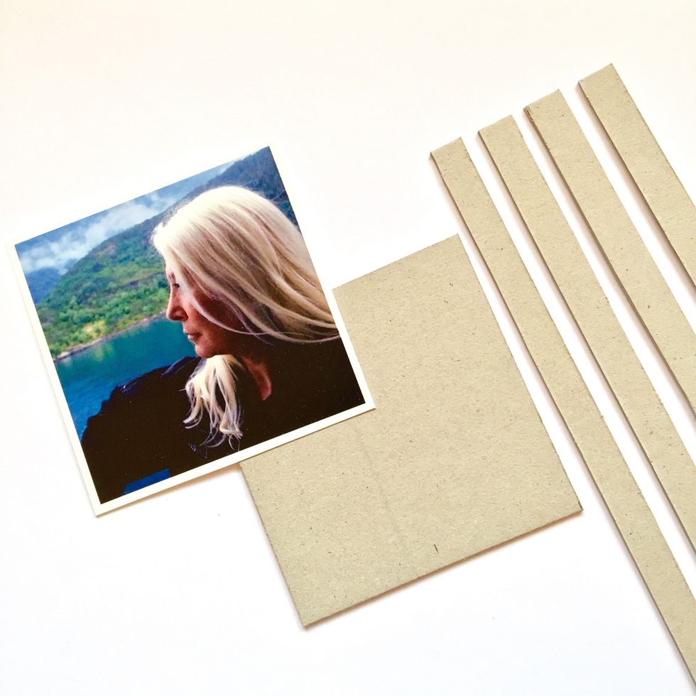 Cut a piece of cardboard the same measures than your photo and four \u00bd\u201d strips to make a base for the photo.
