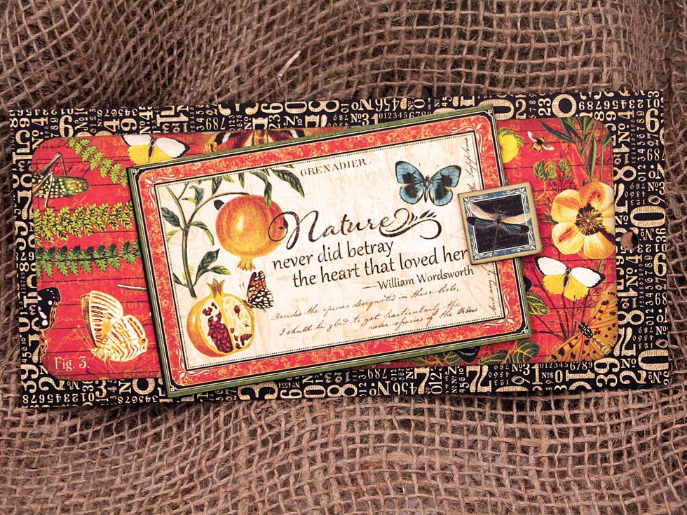 Cut a piece of cardstock 10" x 3 1/4" and fold in half so that it is 5" x 3 1/4".   Adhere a cut-apart to the front of the little book & add a small piece of chipboard to act as a finger hold.