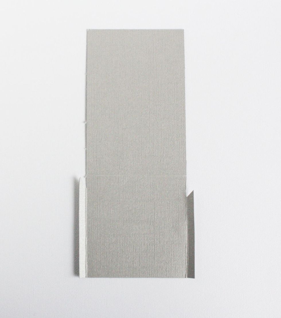 Cut a piece of cardstock 7.5" x 3.5 ". Score at 3". On the 3" side score 1/4" flaps on each side. Trim a small angle near the score.