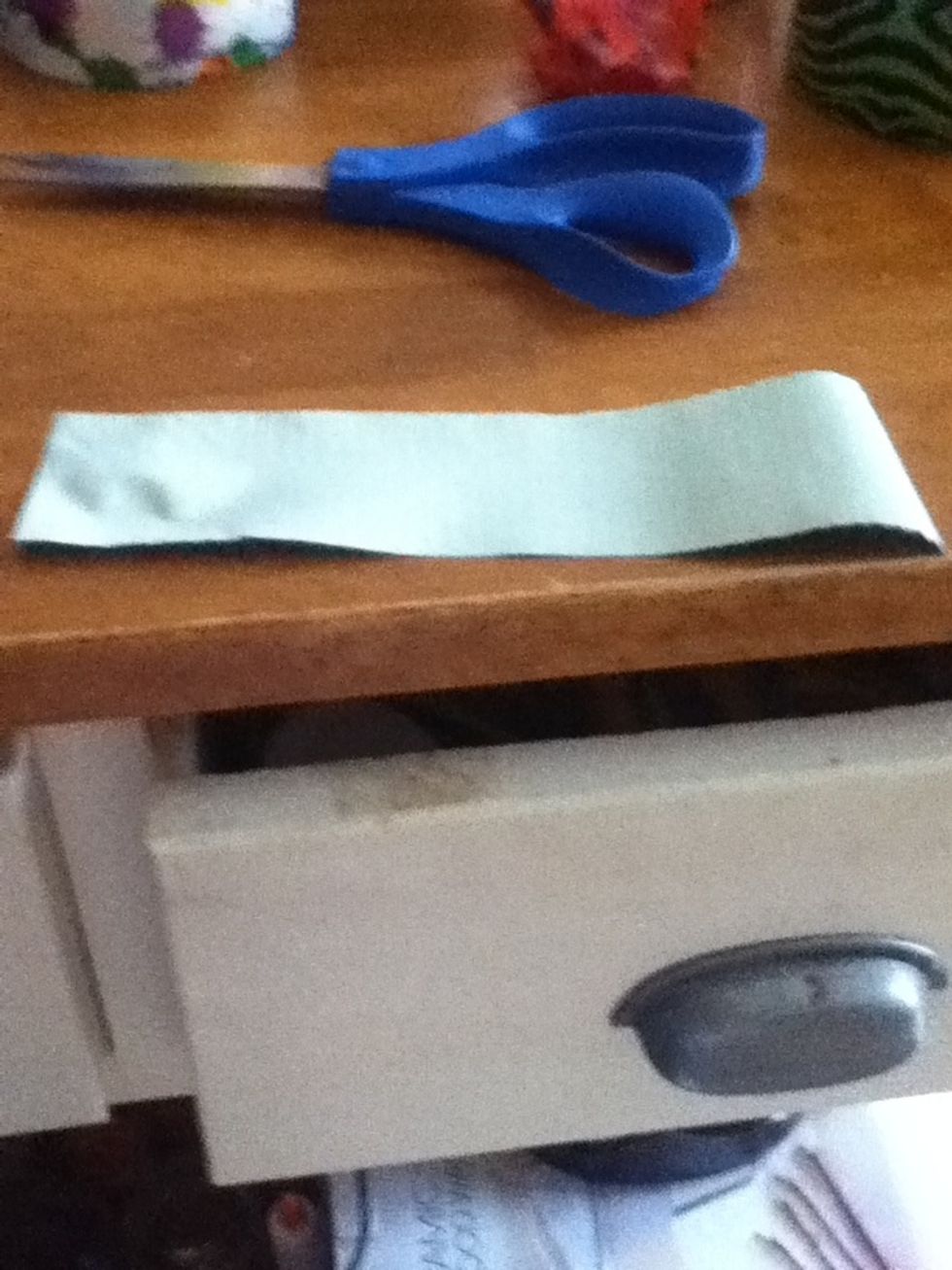 Cut a piece of duct tape about this long. It depends on how big you want your bow.