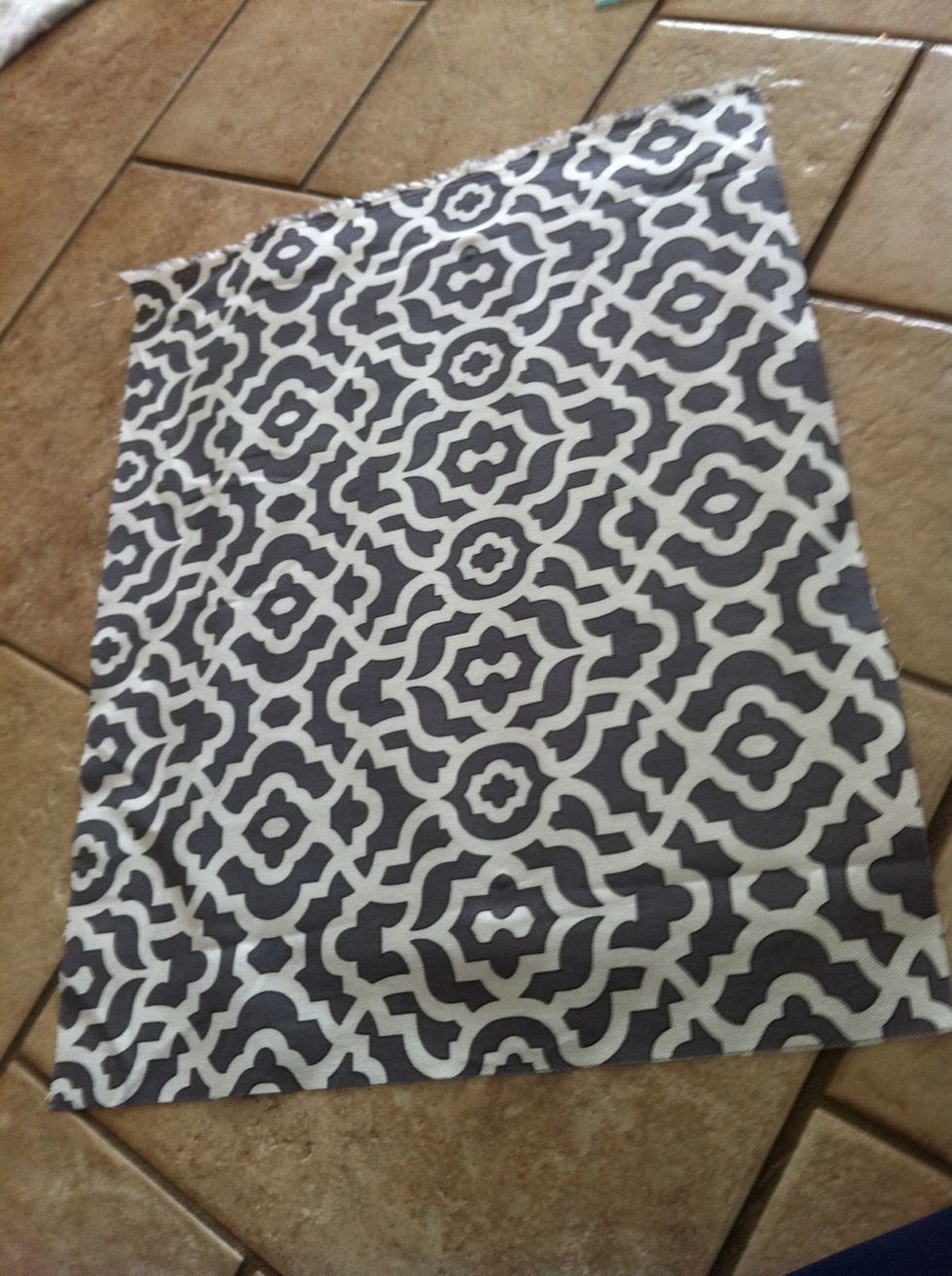 Cut a piece of fabric that is a couple inches wider and longer than the backboard of the frame