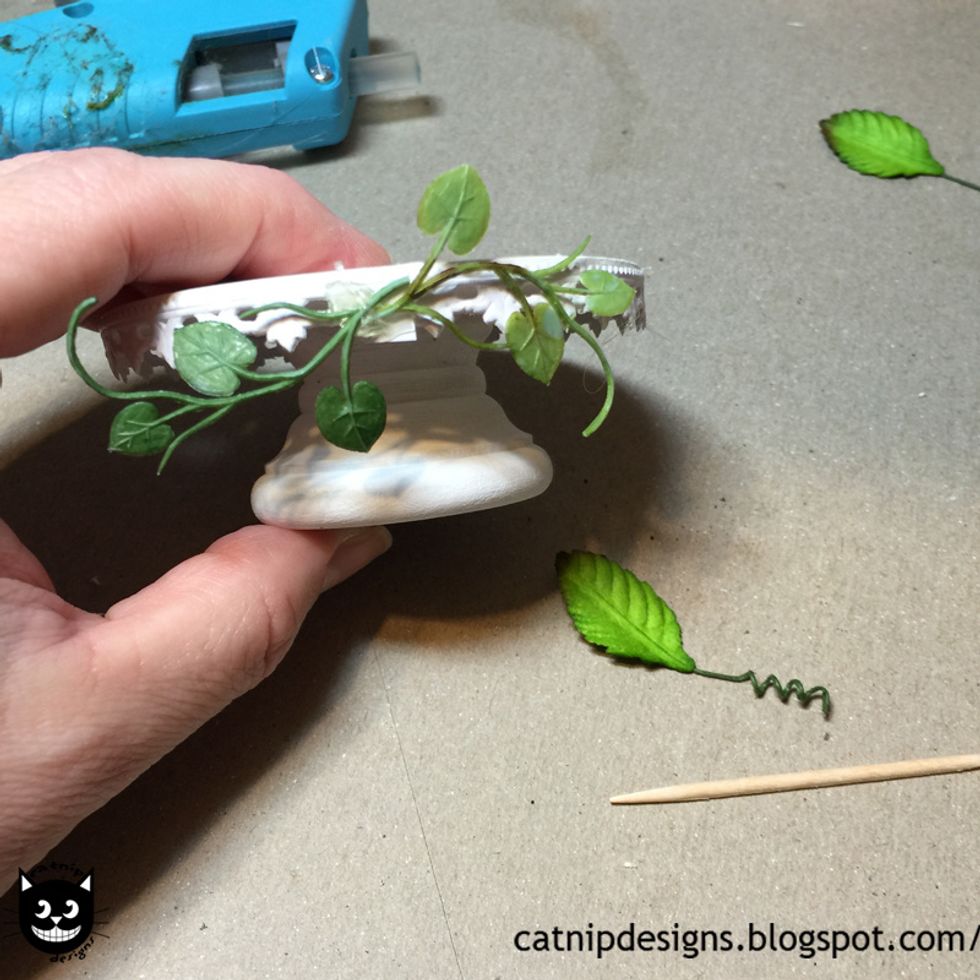 Cut a piece of Fern Garland about 2 inches long. Hot glue it to your base.