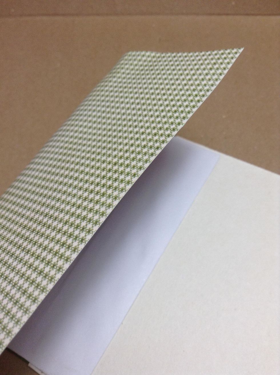 Cut a piece of paper and use adhesive to adhere it to the exterior cardboard roll and covering front as shown.