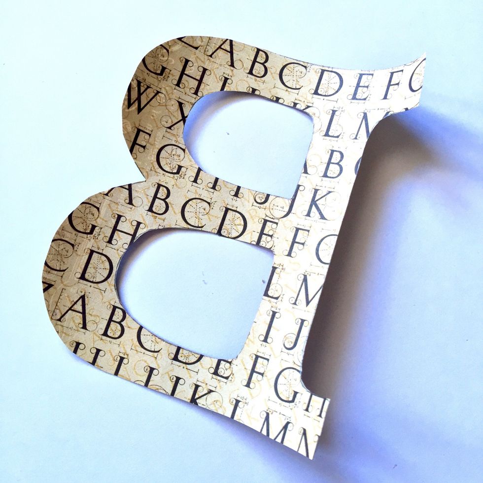 Cut a piece of paper using the letter as a pattern and glue on the back of the letter.
