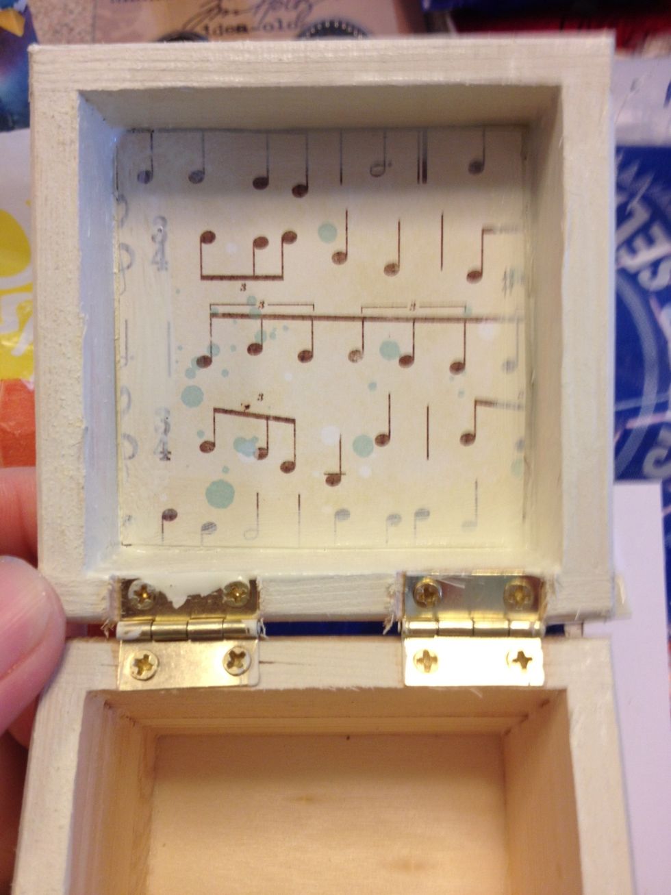 Cut a piece of patterned paper to fit on the inside lid and secure it using mod podge