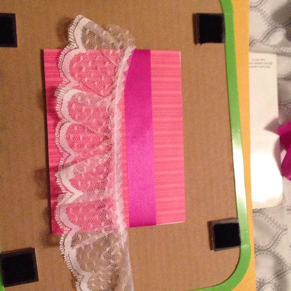 Cut a piece of ribbon and a piece of lace that are the same length as the length of the card.