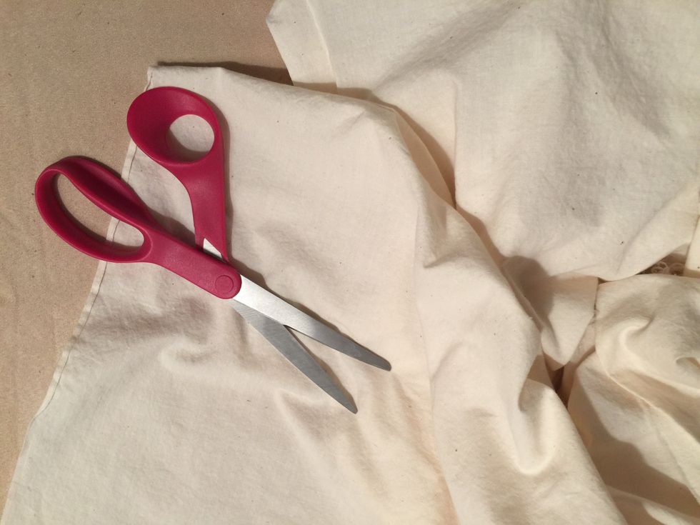 Cut a piece of unbleached muslin large enough to cover the drawing, leaving a 2 inch border around the drawing.