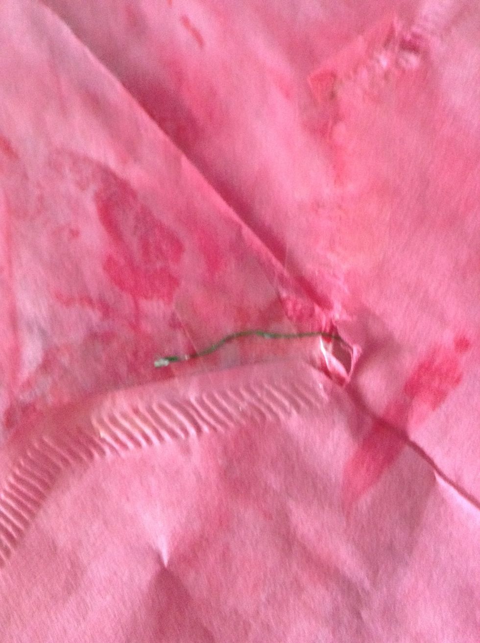 Cut a piece of wire about 25cm, and put it through the hole. Tape the edge down.