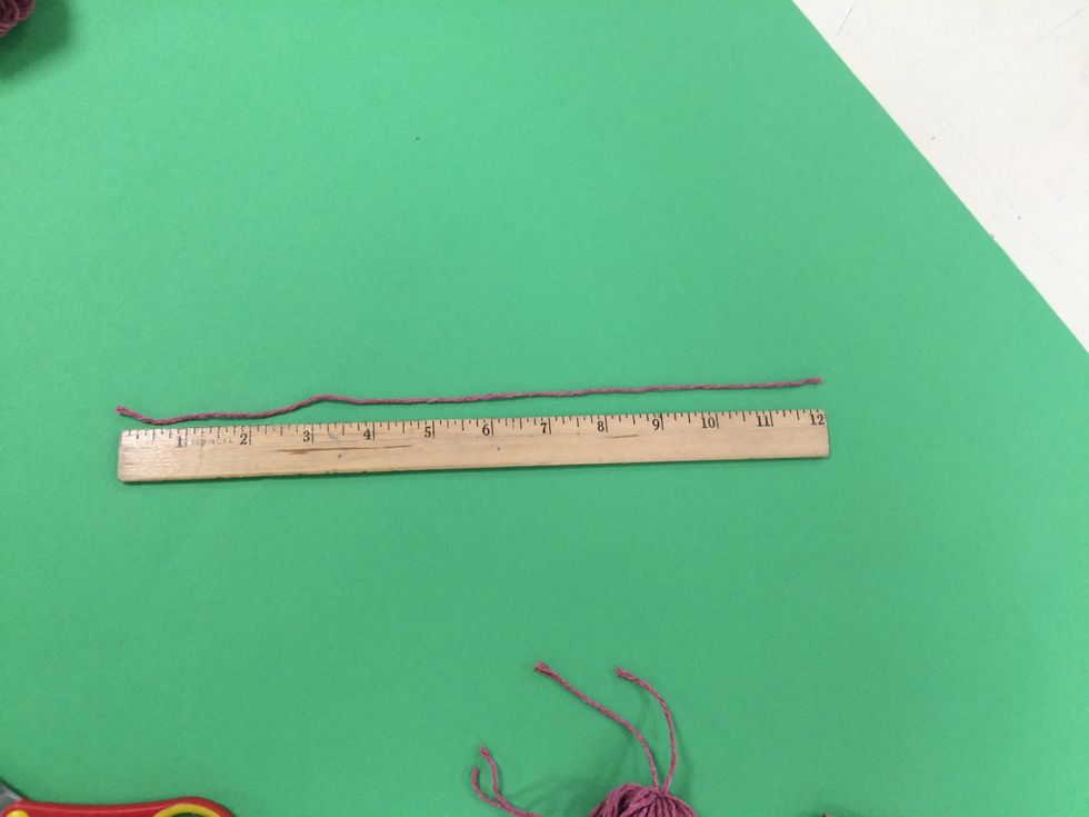 Cut a piece of yarn equaling 12 inches.