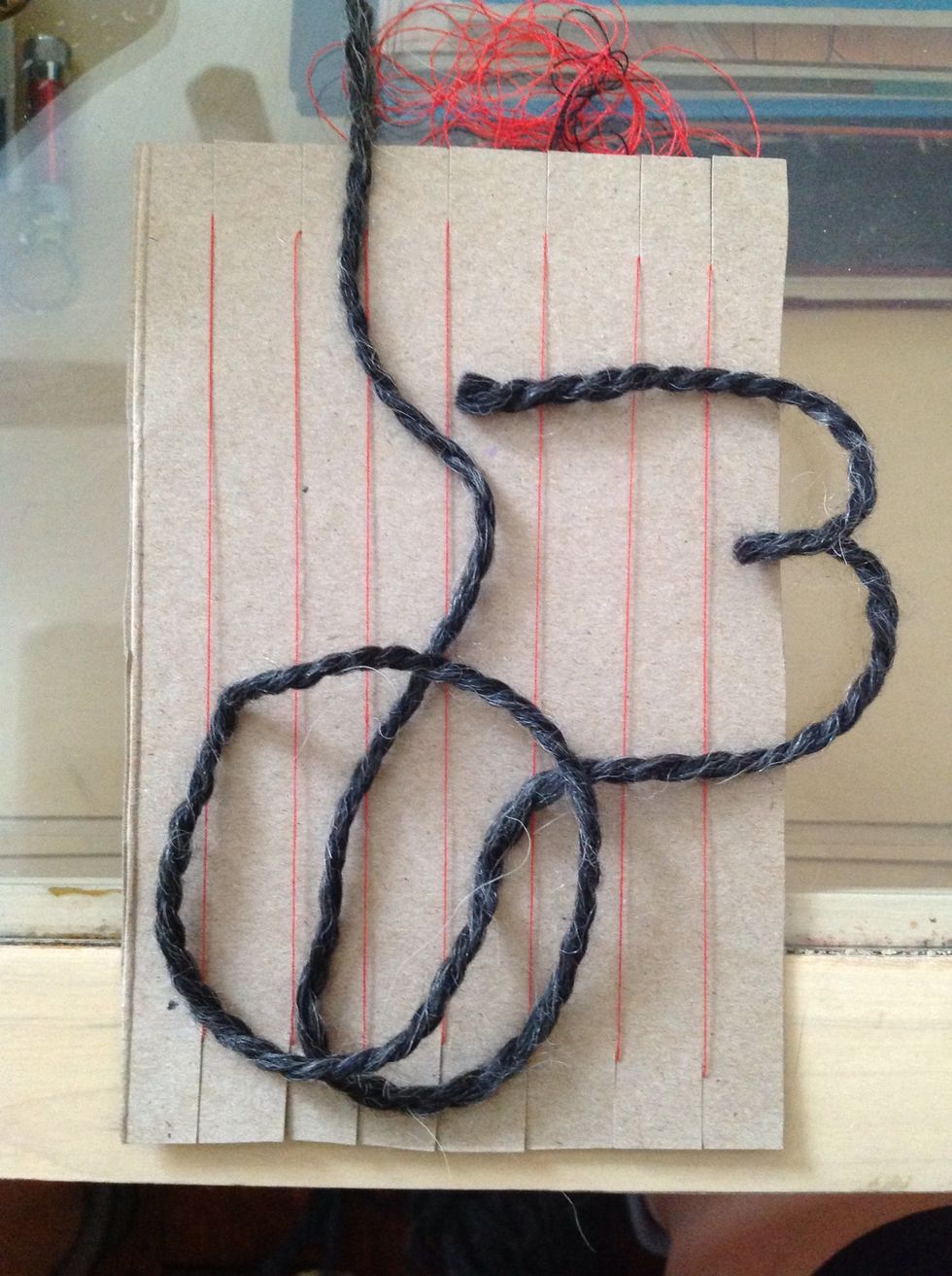 Cut a piece of yarn that is about the length of your arm.