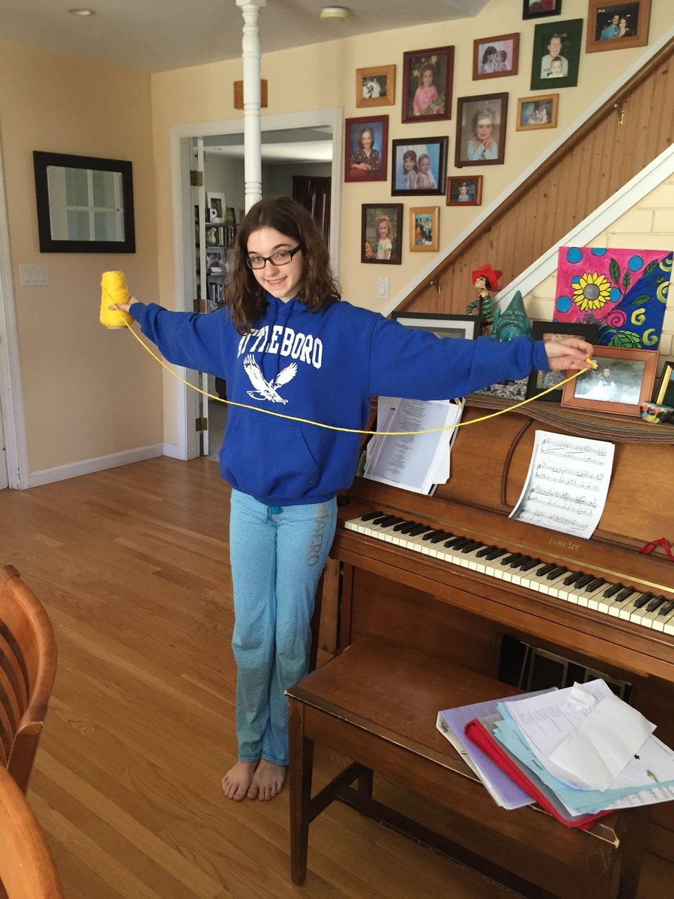 Cut a piece of yarn that is as long as your arm span.