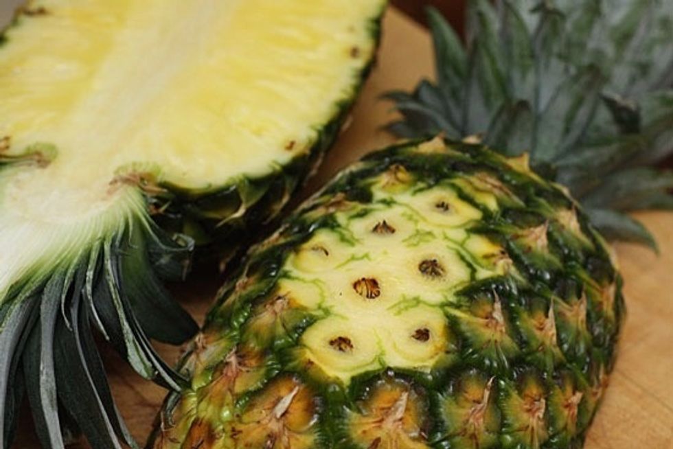 Cut a piece off the bottom of the pineapple halves to create a flat base. Cut the pineapple into small pieces and set aside.