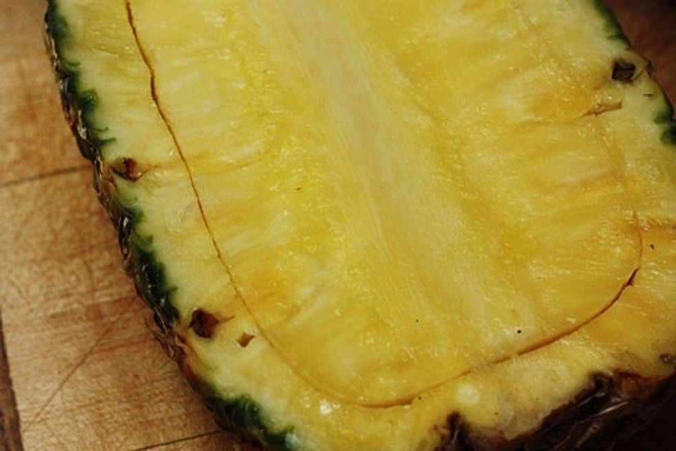 Cut a pineapple in half and hollow out both halves to make two bowls.