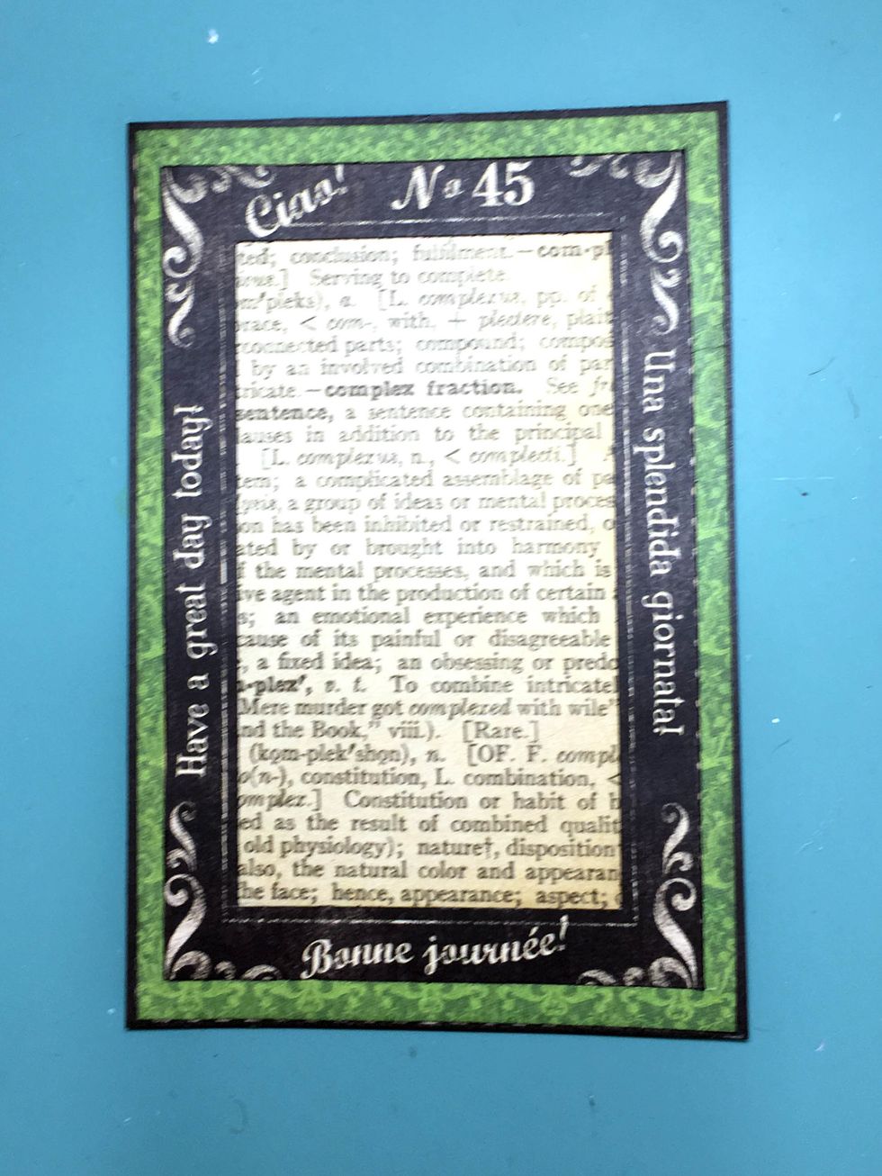 Cut a rectangle from Journey to fit under the layered frames and adhere as shown in the photo.