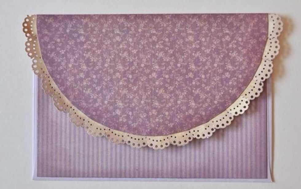 Cut a semi-circle out of the patterned paper & attach to flap of the envelope. Add a punched doily border. Cover bottom of envelope with matching patterned paper.
