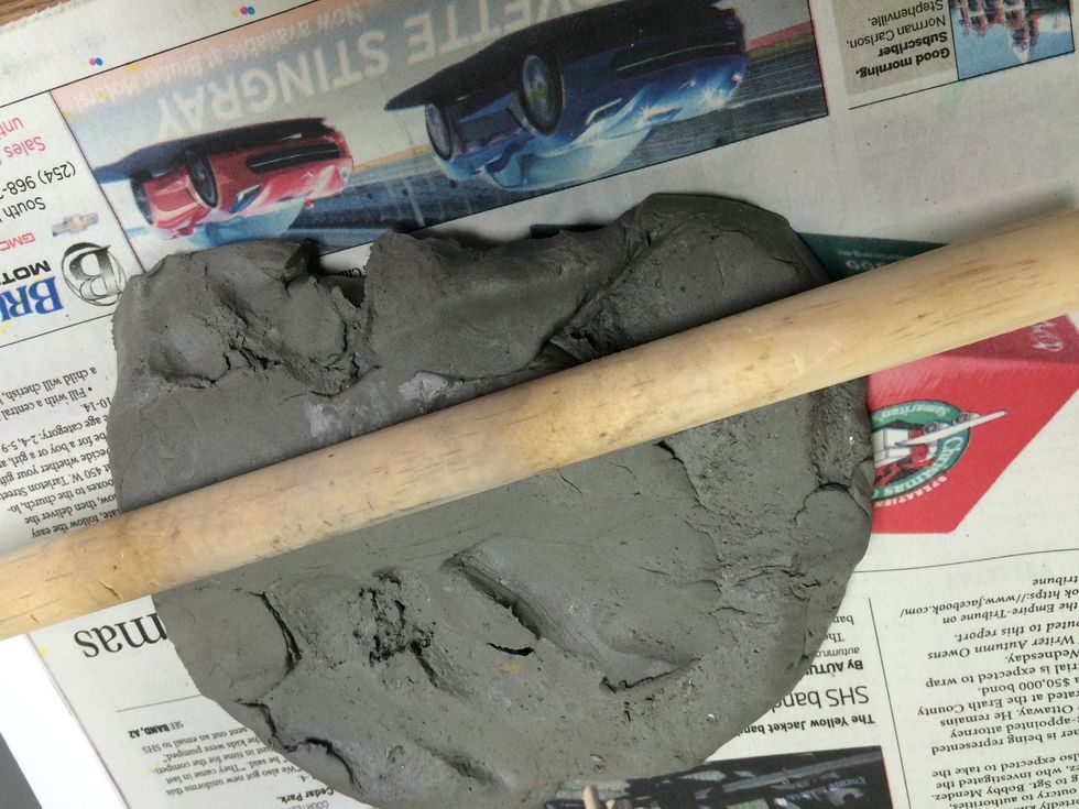 Cut a slab of clay and roll out a slab. You can use a rolling pin. To keep it even, place a yard stick under each end of the rolling pin. You want the thicknes to be about 1/4 inch thick.