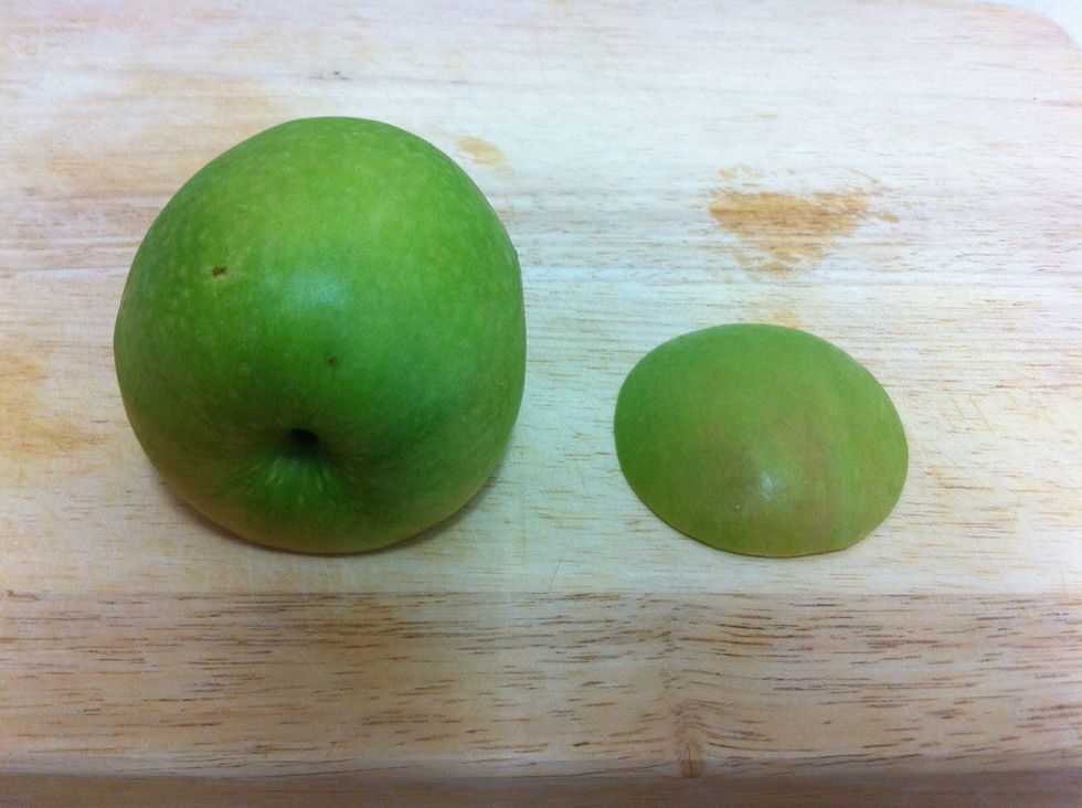 Cut a slice from the apple to make the buttom stable. Save the slice for later
