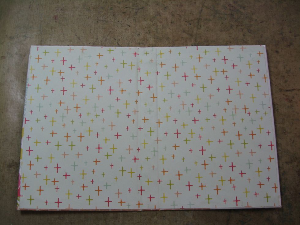 Cut a slightly smaller rectangle of complementary paper and glue to the inside cover. Reinforce the lines along the spine with bone folder. Burnish paper to get rid of air bubbles.