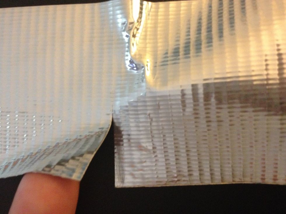 Cut a slit about halfway across the duct tape where both the marks you just made are.