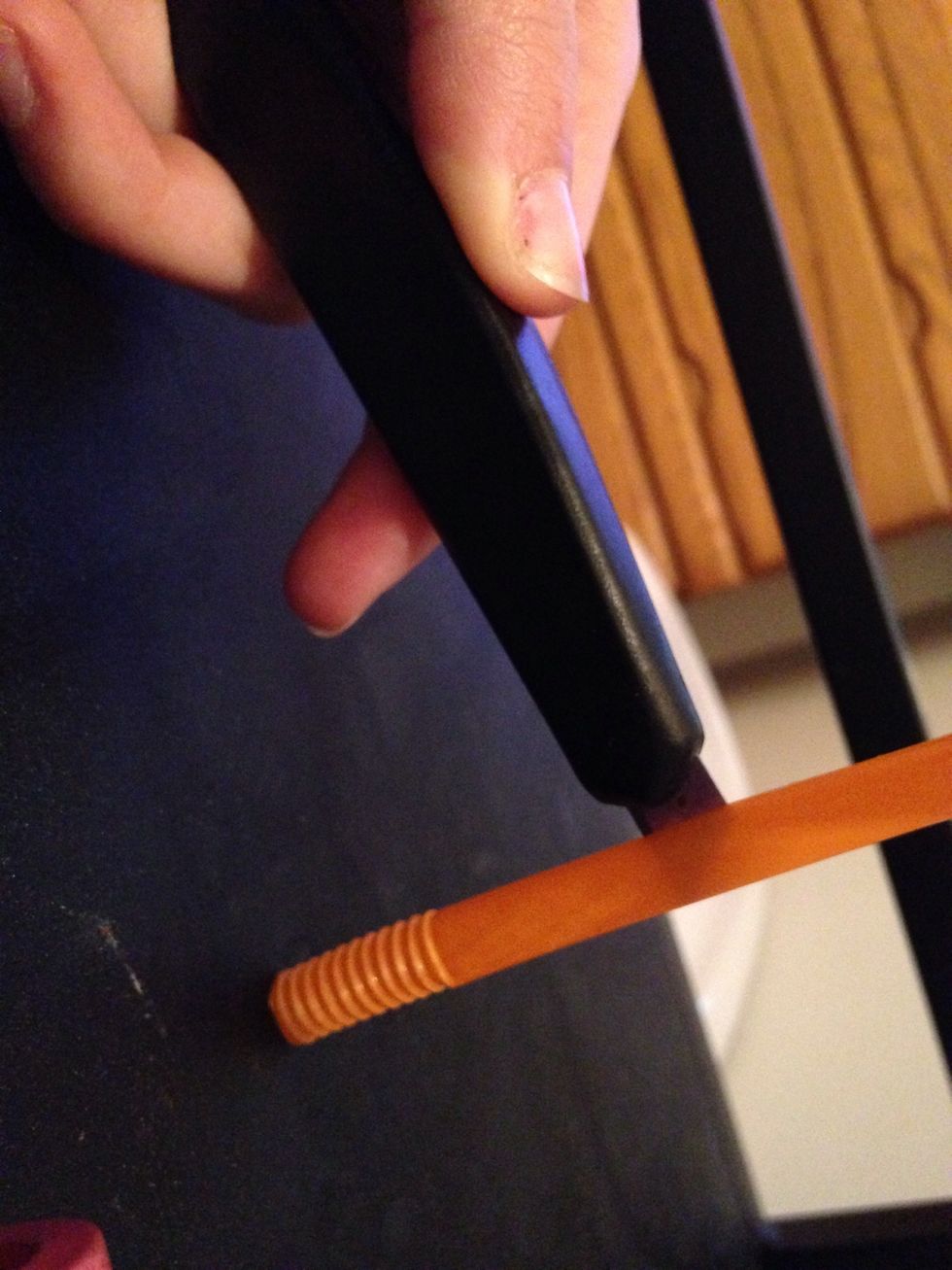 Cut a slit down the middle of the straw. (You can use scissors)