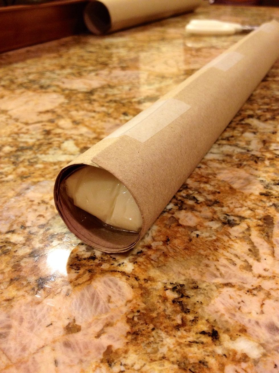 Cut a slit down the side of the roll so you can open it. Tightly wrap the candy in the tube and tape it closed. Now place that in the fridge until very firm, about 45 minutes.