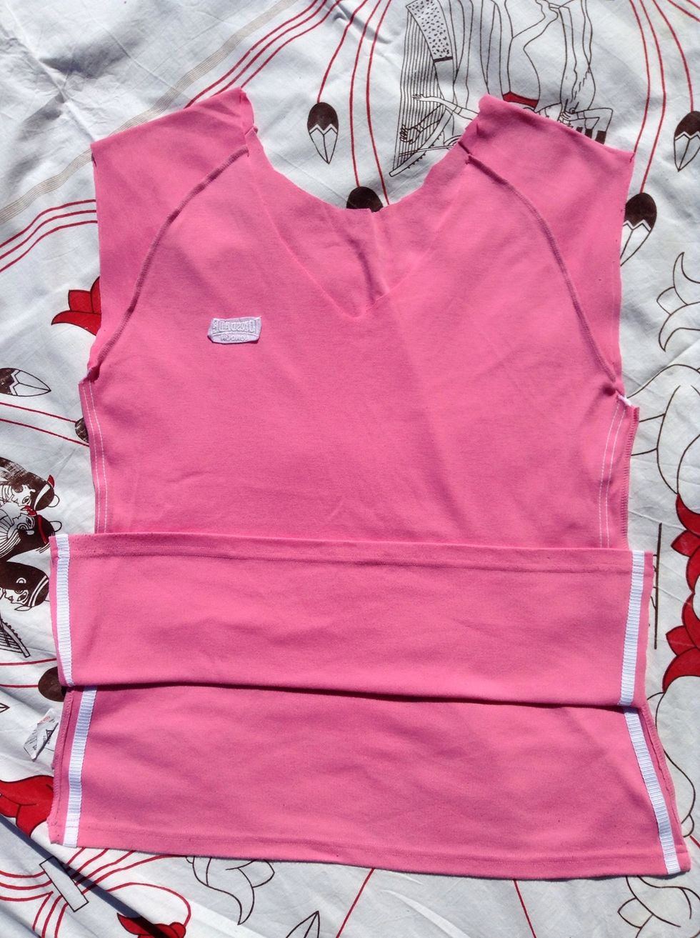 Cut a slit on either side of the shirt. The length of the slit depends on how big you want your tote. Where I've folded it shows where the bottom of the tote will be.