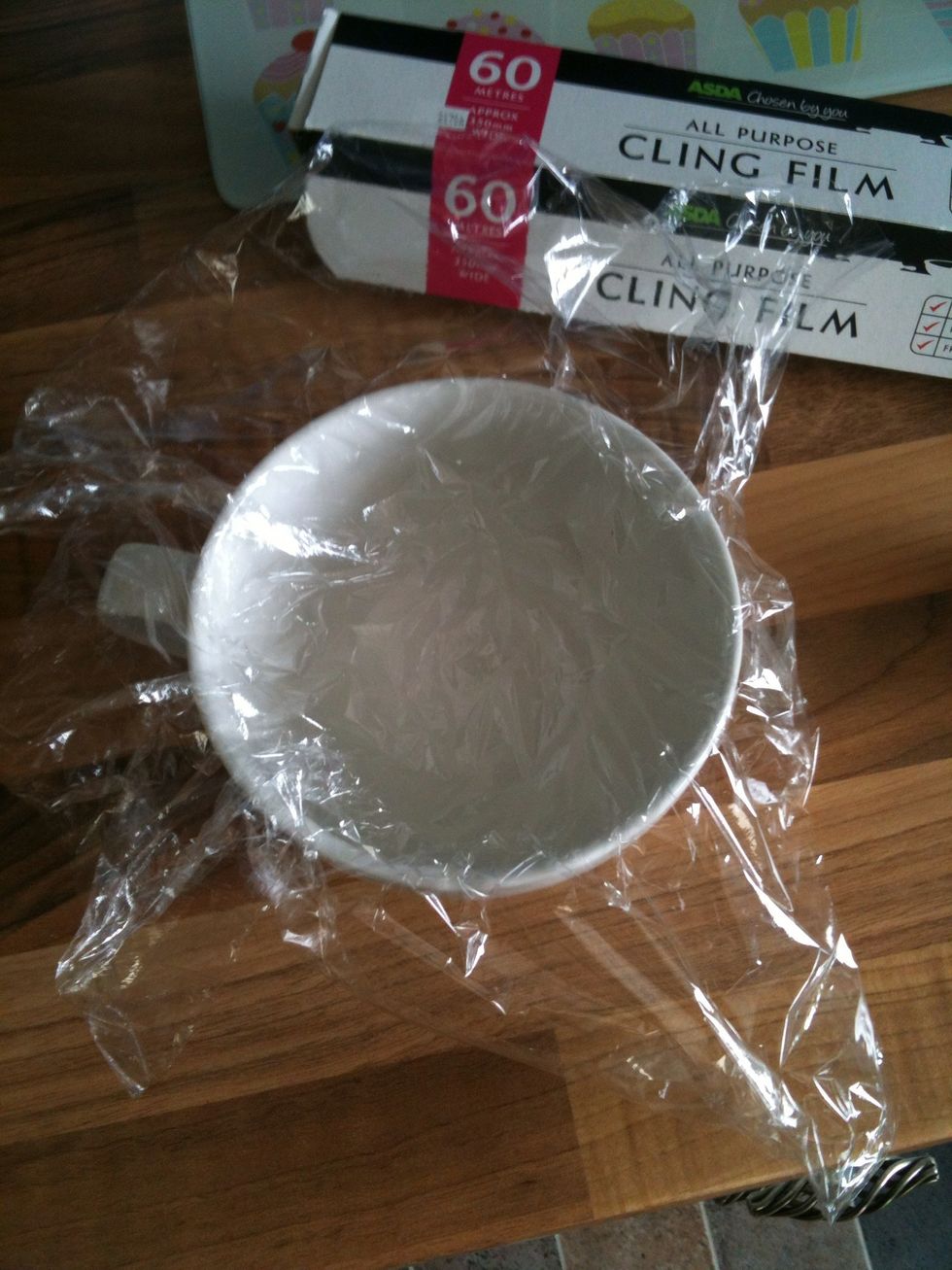 Cut a square of wrap and push the centre of it down into the cup, ensuring that all sides are covered and you have plenty of excess overlapping the edges.