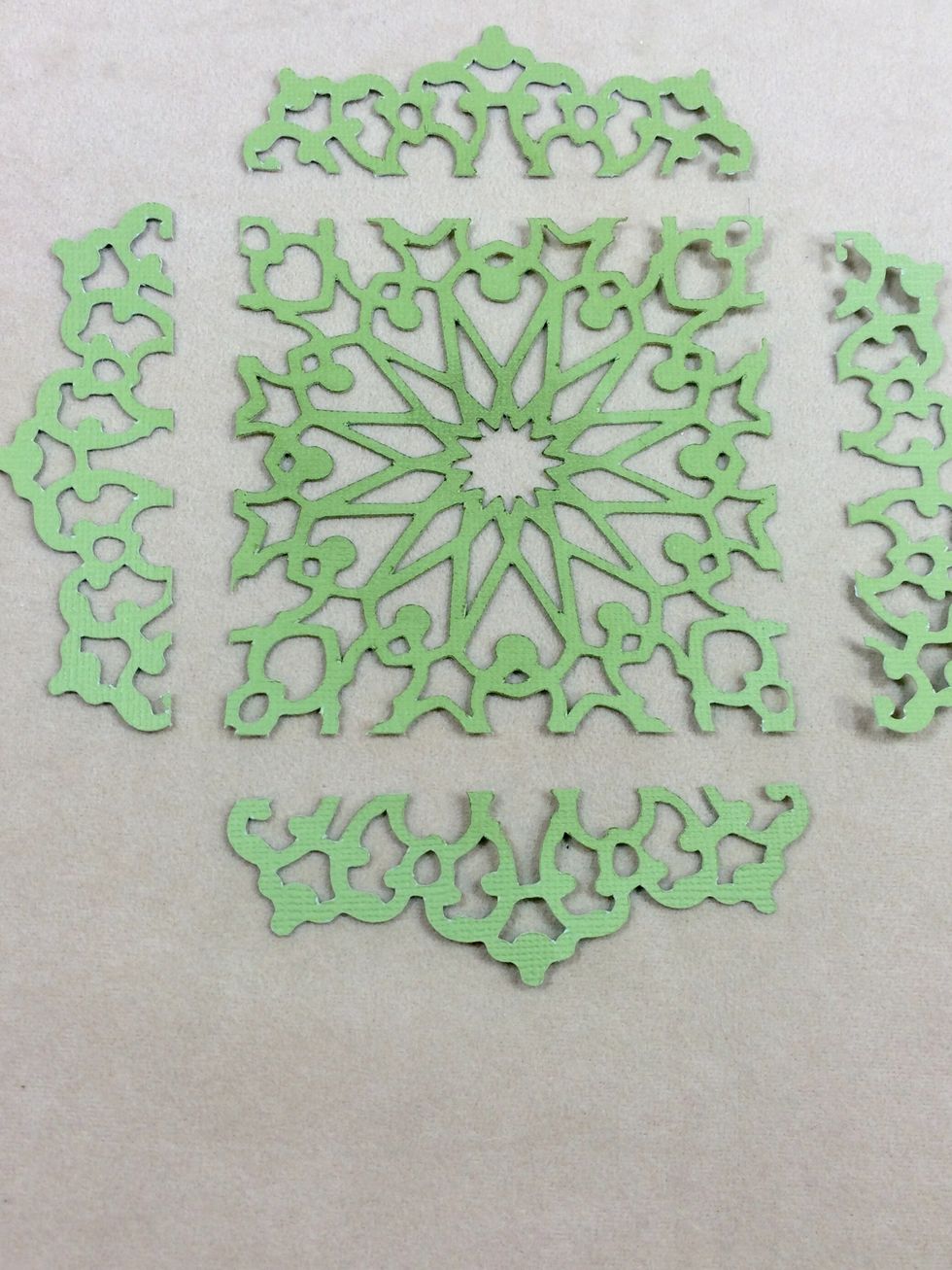 Cut a square out of a doily shape to 3 1/2" x 3 1/2", keeping the remaining pieces. Mine is cut from the Art Philosophy Cricut cartridge at 5" onto green cardstock.