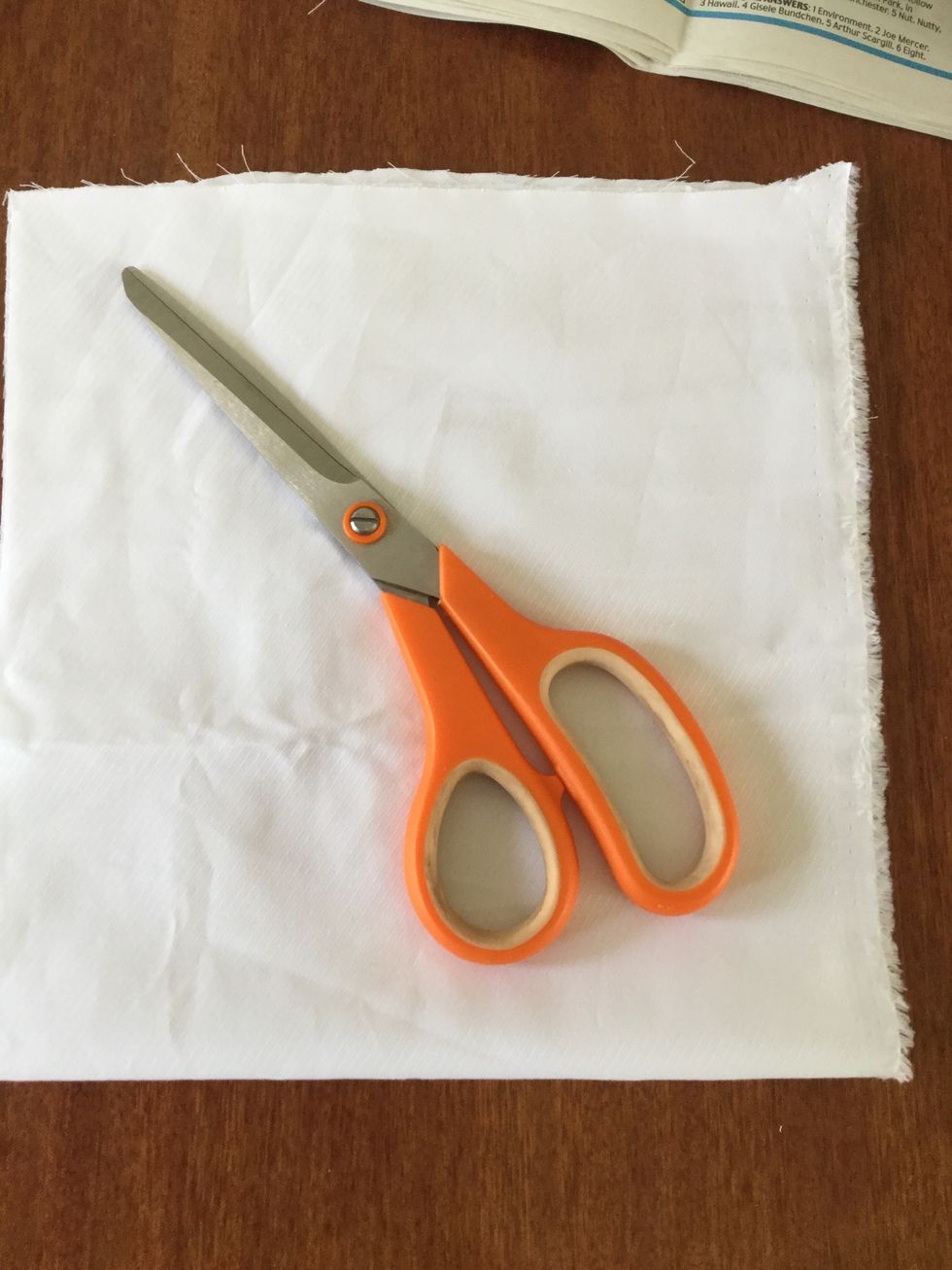Cut a square out of the fabric you want to use with some scissors or fabric scissors.