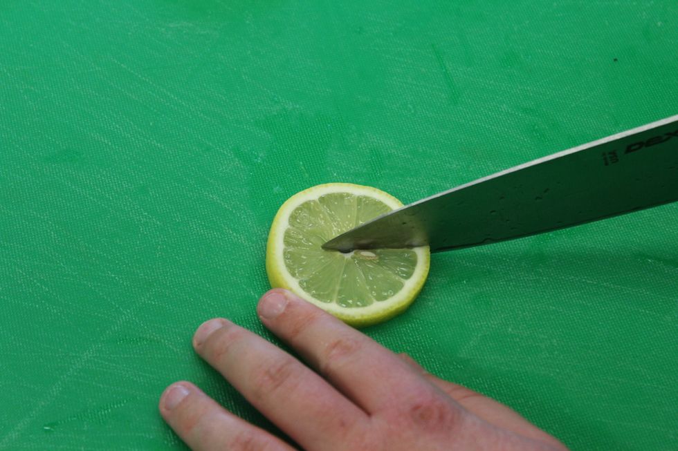 Cut a straight line from the middle of them lemon all the way to the edge of the lemon.