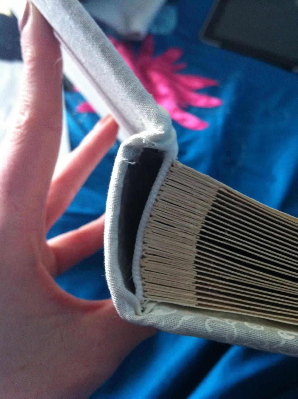 Cut a straight line in the material at edge of spine then glue and fold in
