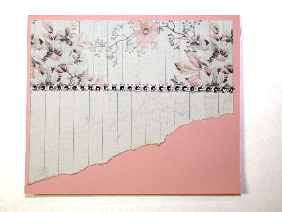 Cut a string of bling, pearls, whatever you desire, and adhere where the two patterned papers meet, 2 1/8" from the top.