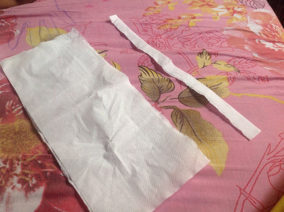 Cut a strip from the tissue.