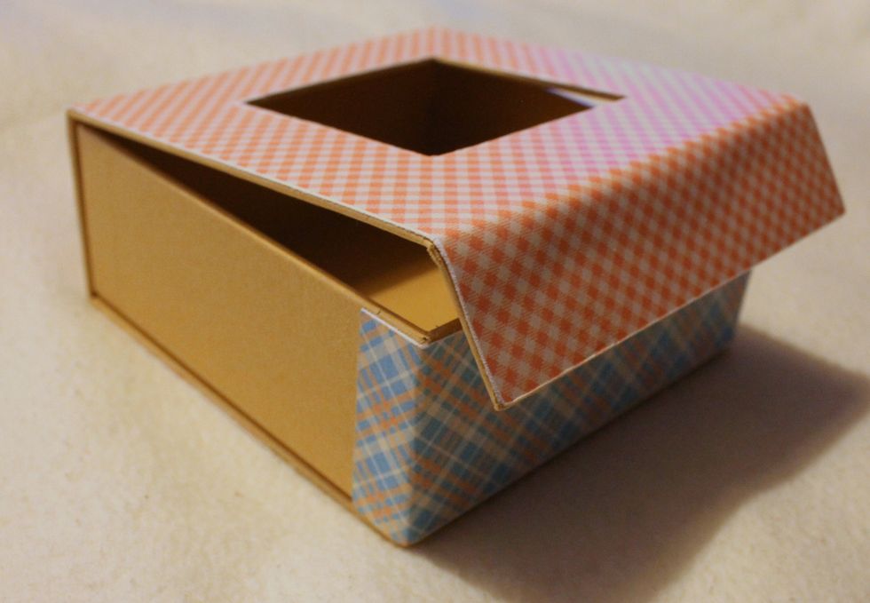 Cut a strip of 7x2' from another sheet of paper. Fold it in two places and adhere it to the side of the box.