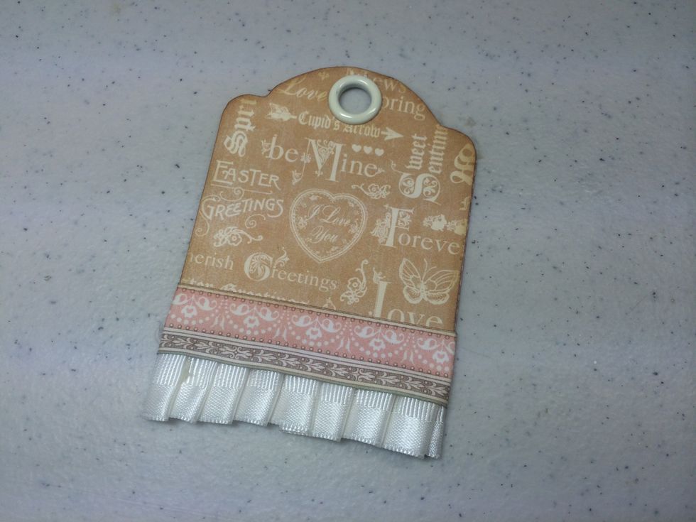 Cut a strip of coordinating paper and adhere with Scor-Tape or other strong adhesive. This covers any glue or staples.