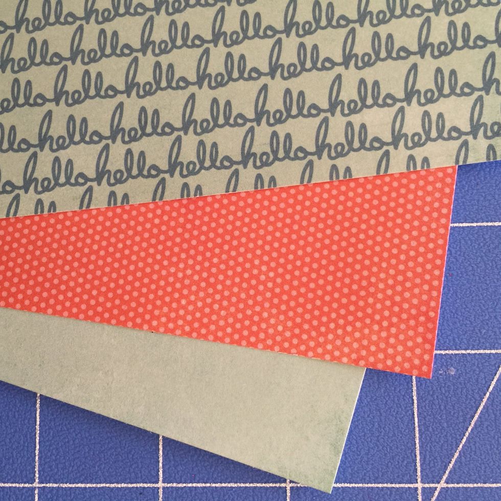 Cut a strip of plain blue paper measuring 1 " x 5 1/2. Punch scallops using an edge punch. Adhere to bottom of orange strip so that the scallops extend from the edge.