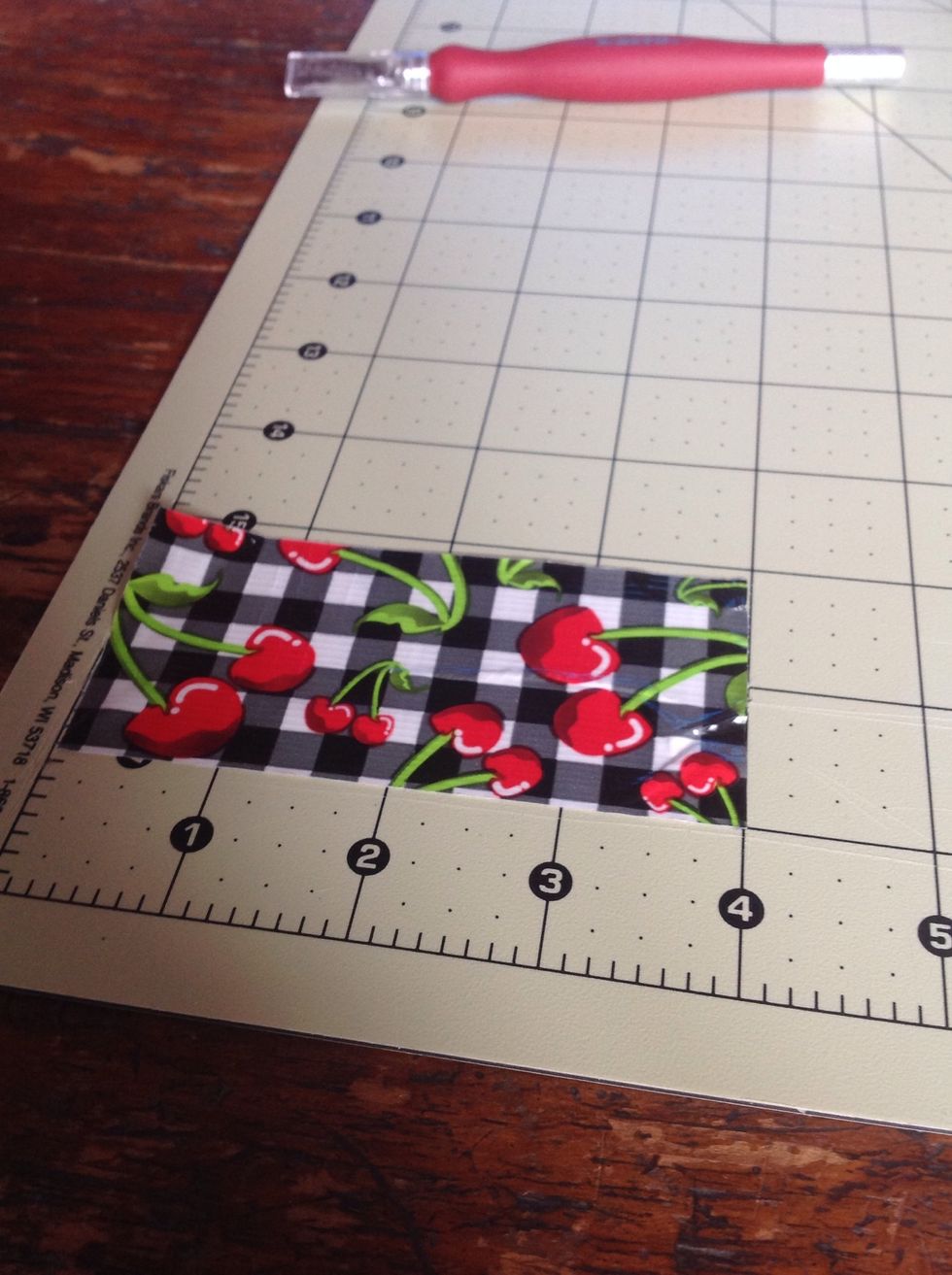 Cut a strip of tape that is 3-4 inches long. As u can see my strip if 4 inches long
