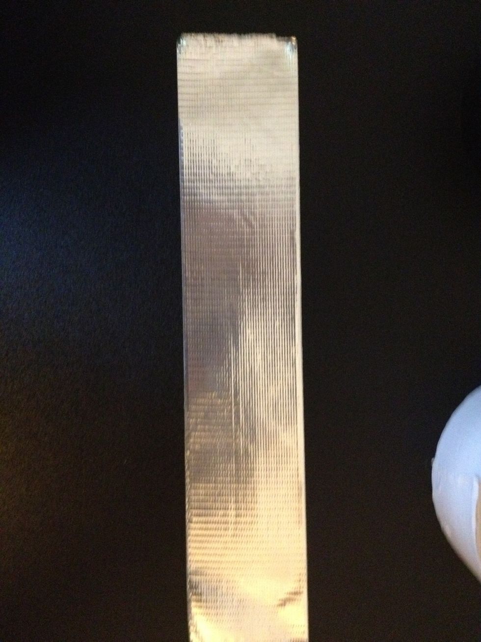 Cut a strip of your (or one of your) background color(s) that is a little more than twice the length of one of the dimensions of your cardboard.