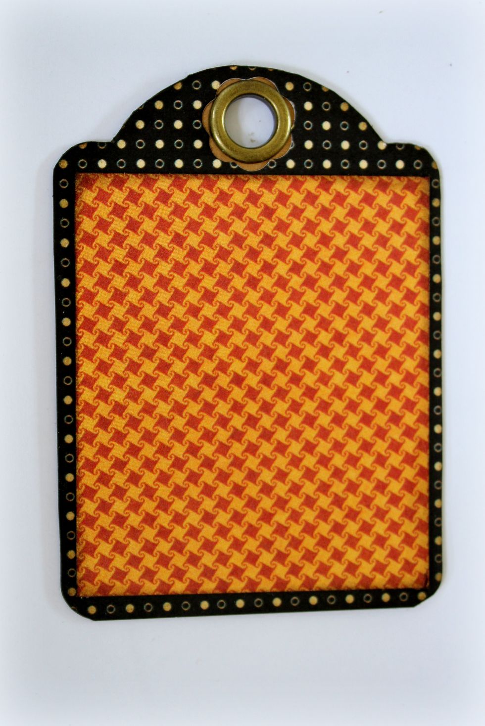 Cut a tag from black paper and attach it to the ATC kraft tag. Cut a small rectangle from a tangerine sheet of paper and attach it onto the tag as well. Use ink to make the edges stand out more.