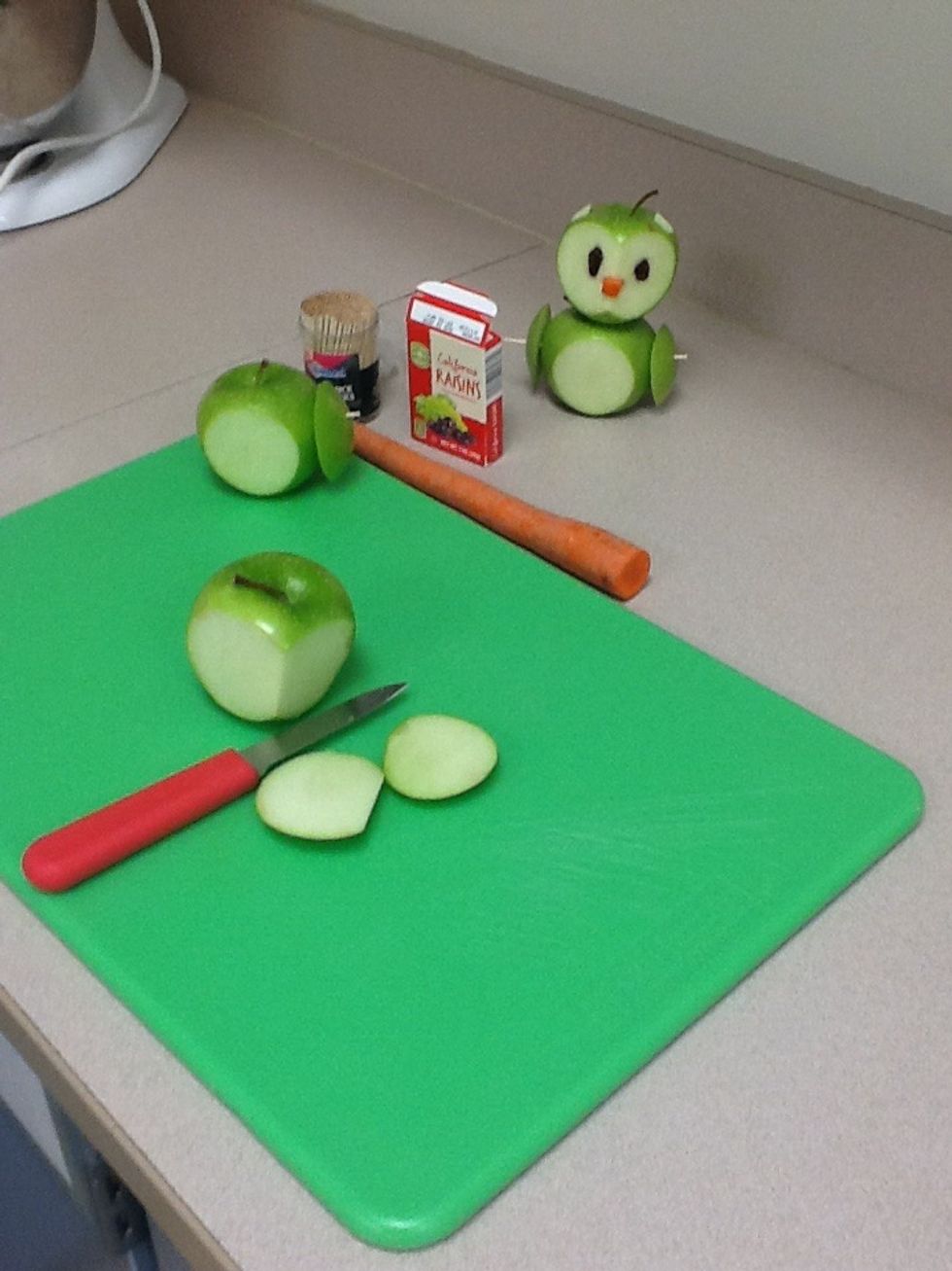 Cut a v shape out of the 2nd Apple to make the face of an apple
