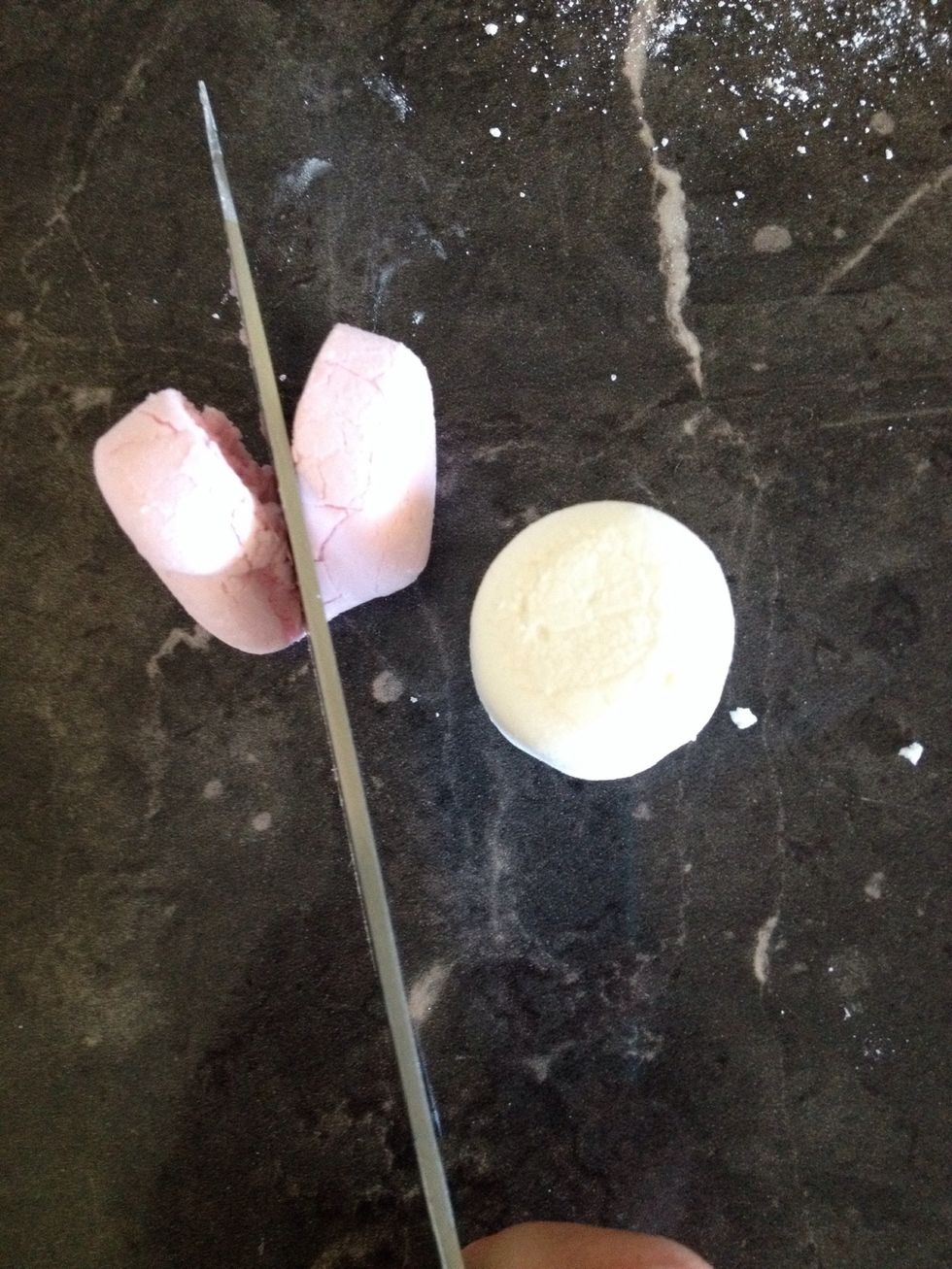 Cut a white and a pink marshmallow in half.