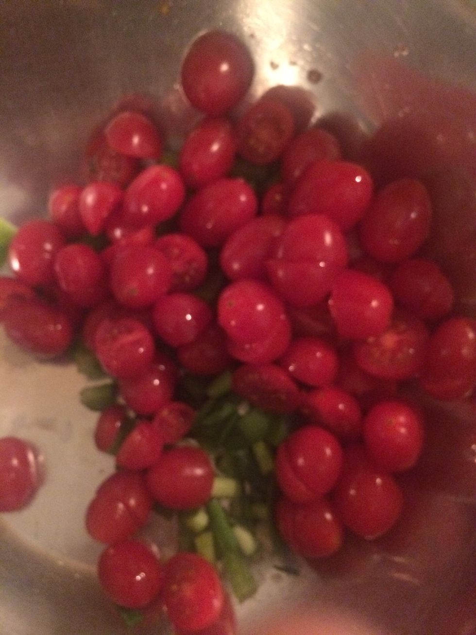 Cut about 1 cup of cherry tomatoes in half and add to bowl, add salt and pepper