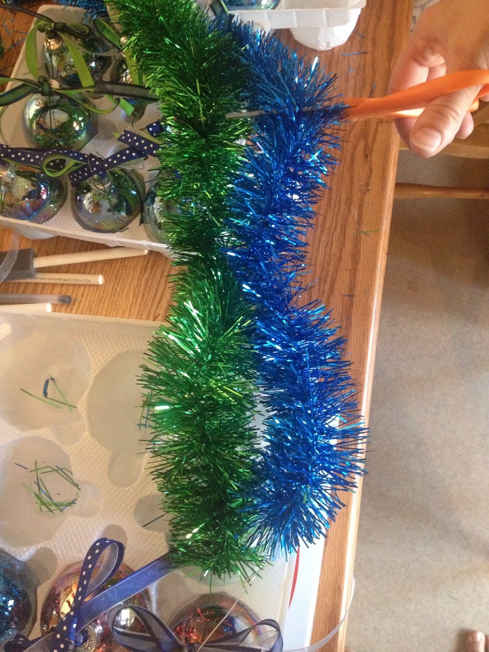 Cut about a foot length piece of each color of tinsel garland.