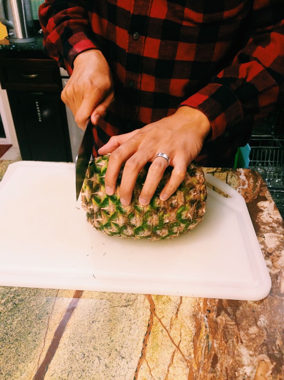 Cut about an inch off from top and bottom of pineapple