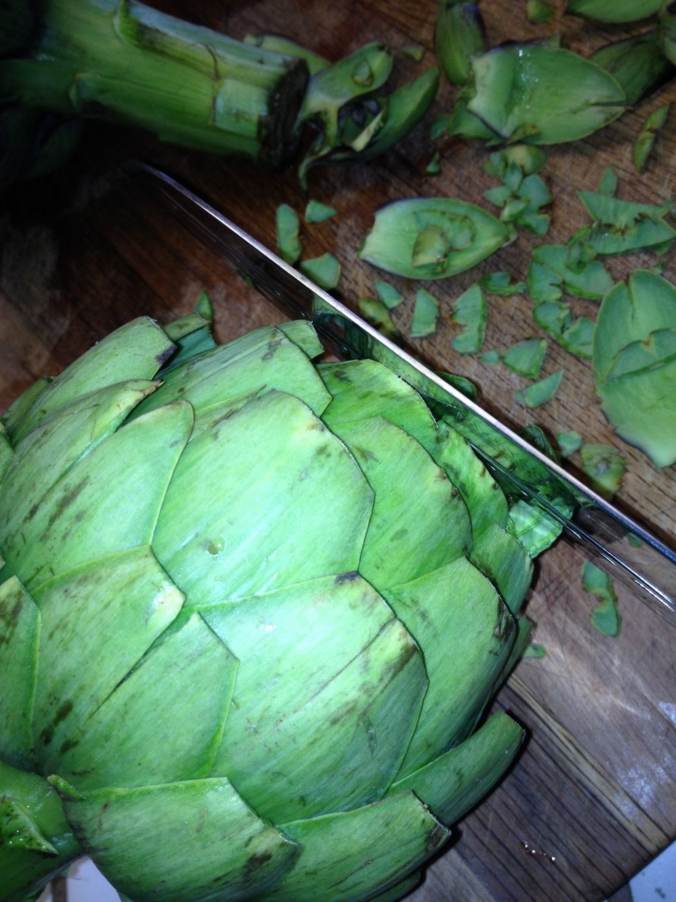 cut about an inch off the tops and cut stems off (if desired) so the artichoke sits flat.
