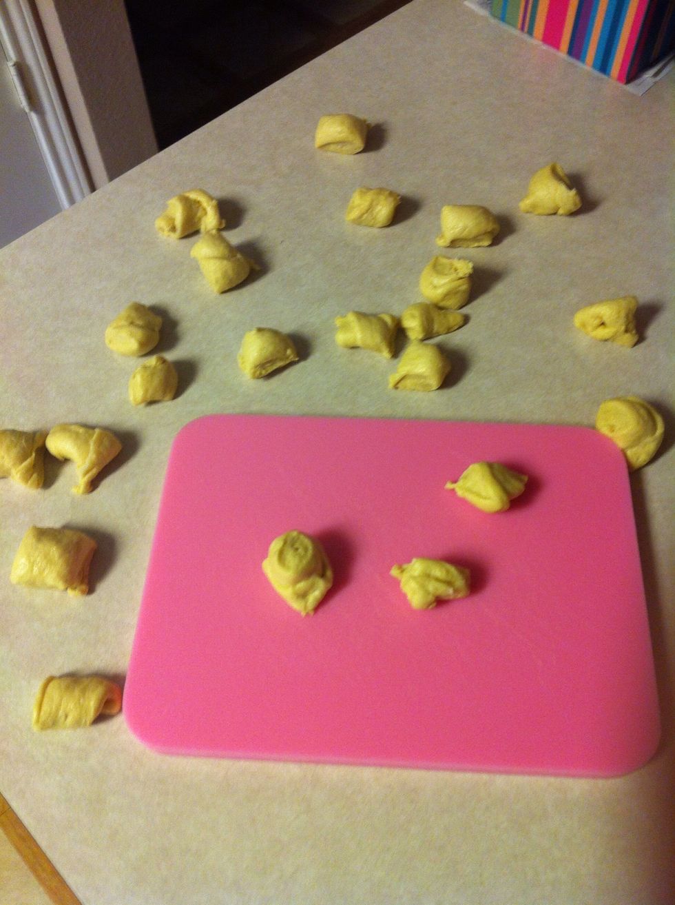 Cut all of your rolls into decent size pieces. Don't cut them too big or your monkey bread will be huge! Haha :)