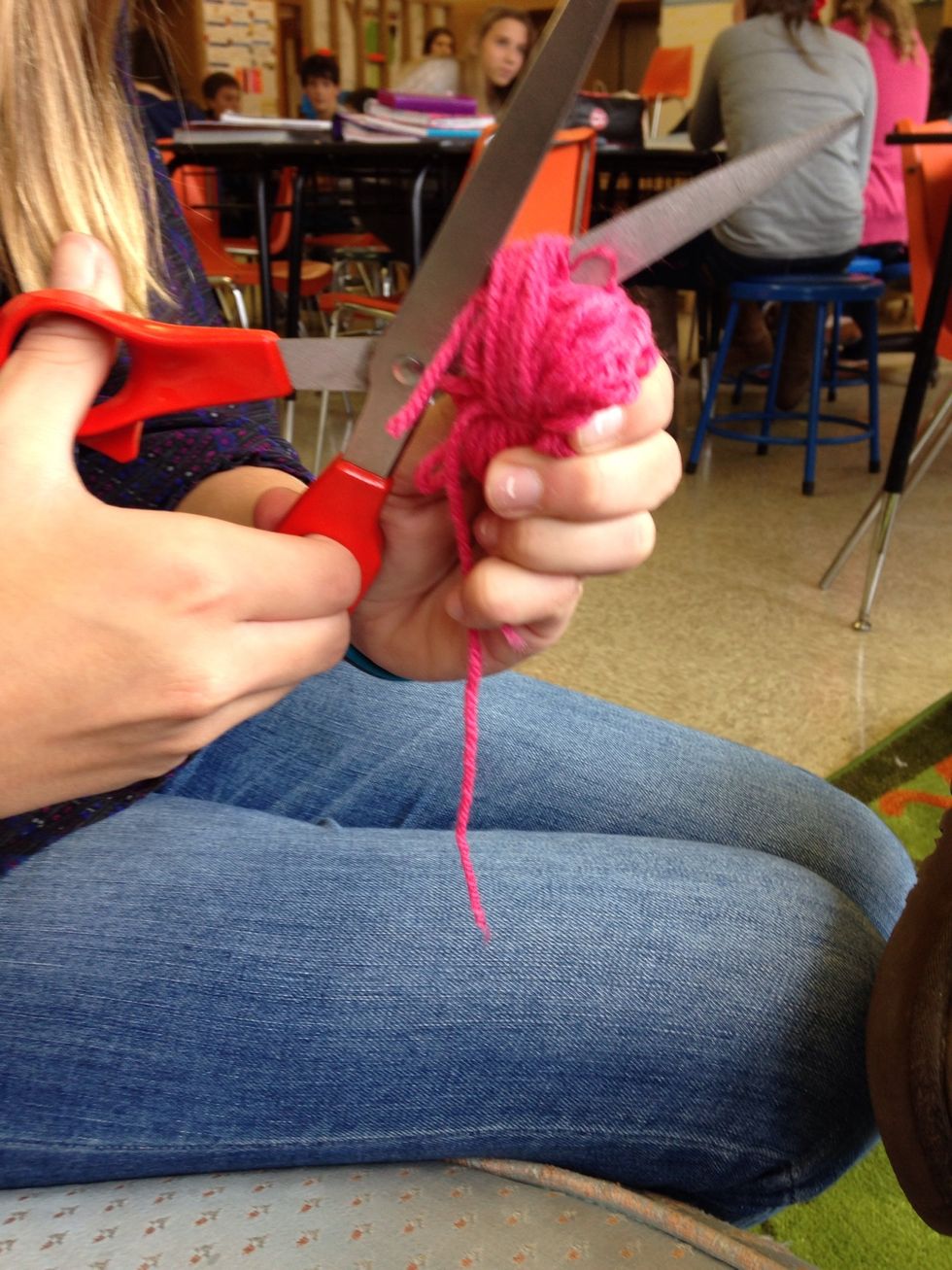 Cut all the different rolls of yarn at the top with scissors
